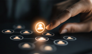 Hand reaching toward a glowing contact icon among a grid of user profile symbols on a digital screen