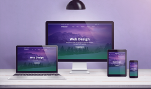 Web design displayed consistently across desktop, tablet, and smartphone on a desk setup