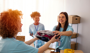 Non-profit volunteers handing out clothing and supplies during a donation drive.