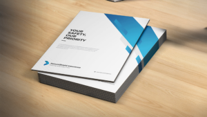 Stack of white folders featuring a blue geometric design and tagline about safety and trust.