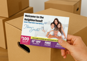 Dental welcome postcard offering new patient specials, held in front of moving boxes.