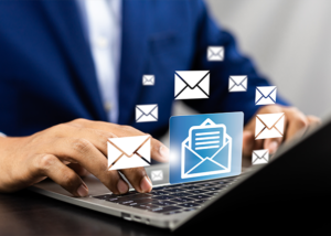 Digital envelopes hovering over a laptop, symbolizing real-time mail tracking and reporting.