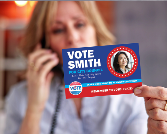 Woman holding a Vote Smith postcard while making a phone call, engaging with political direct mail.